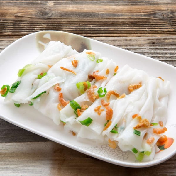 Delicious Food Corner's Chinese rice noodle rolls with dried shrimp and green onions on a white plate.